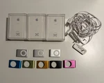 Apple Ipod Shuffle 2ND Generation Bundle Of 3 Boxes, Docks, Headphones, Covers. Fixed Price $100.00.